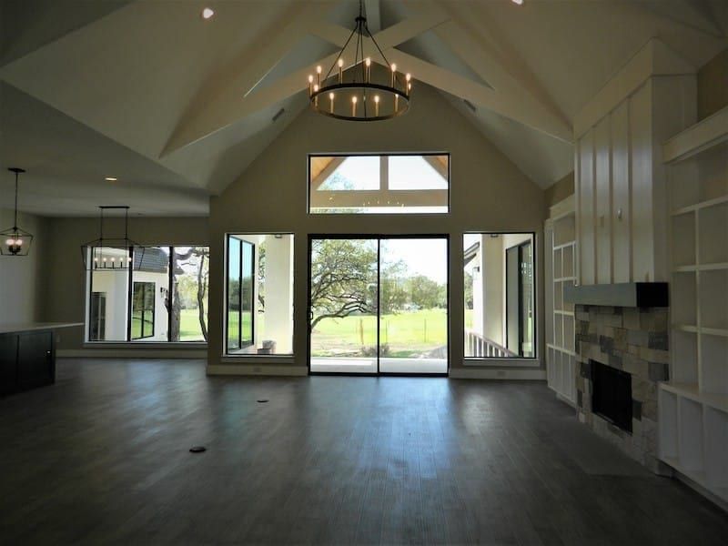 Spacious living room with vaulted ceiling in Summer Oaks Custom Home in Austin, TX
