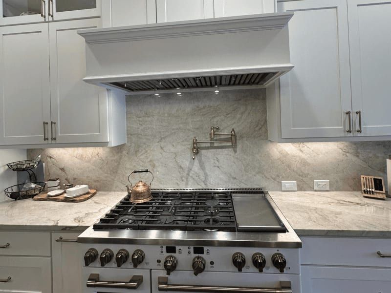 Stovetop and marble backsplash in the Hoover kitchen remodel