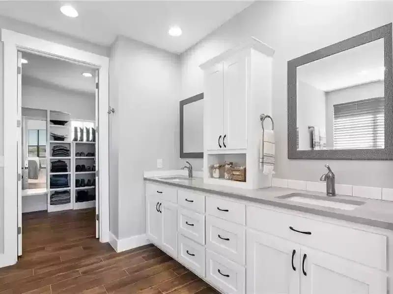 Spacious bathroom with double vanity and walk-in closet in a renovated Austin, TX home