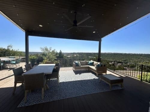 A patio with outdoor furniture, with a view of the mountains