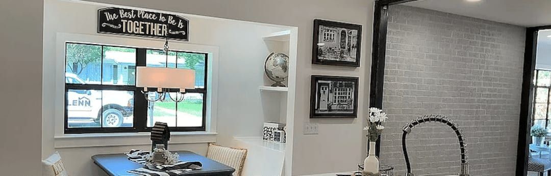 Breakfast nook beside the kitchen, with a black steel casement window and a grey brick wall