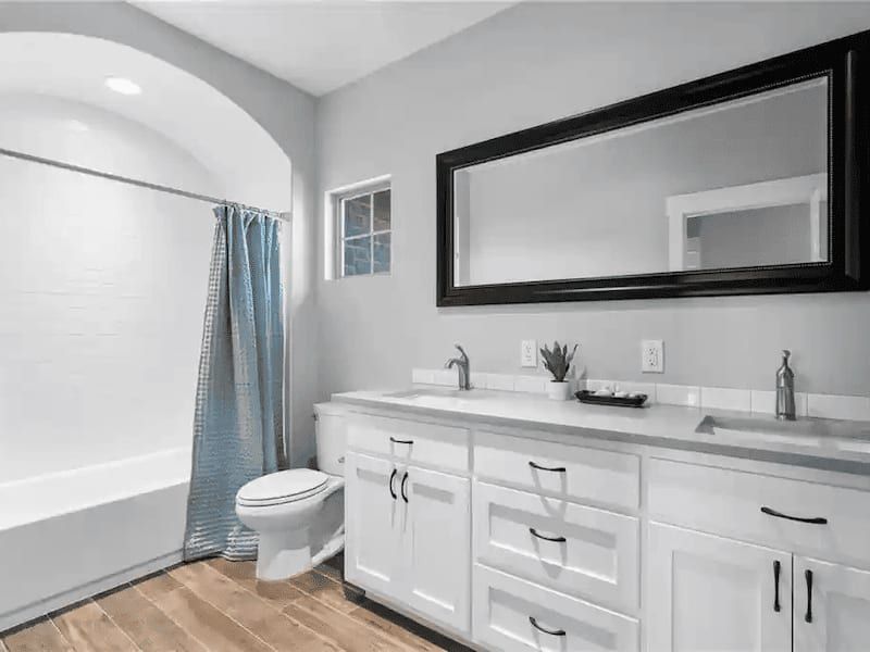 Remodeled bathroom with white and steel accents