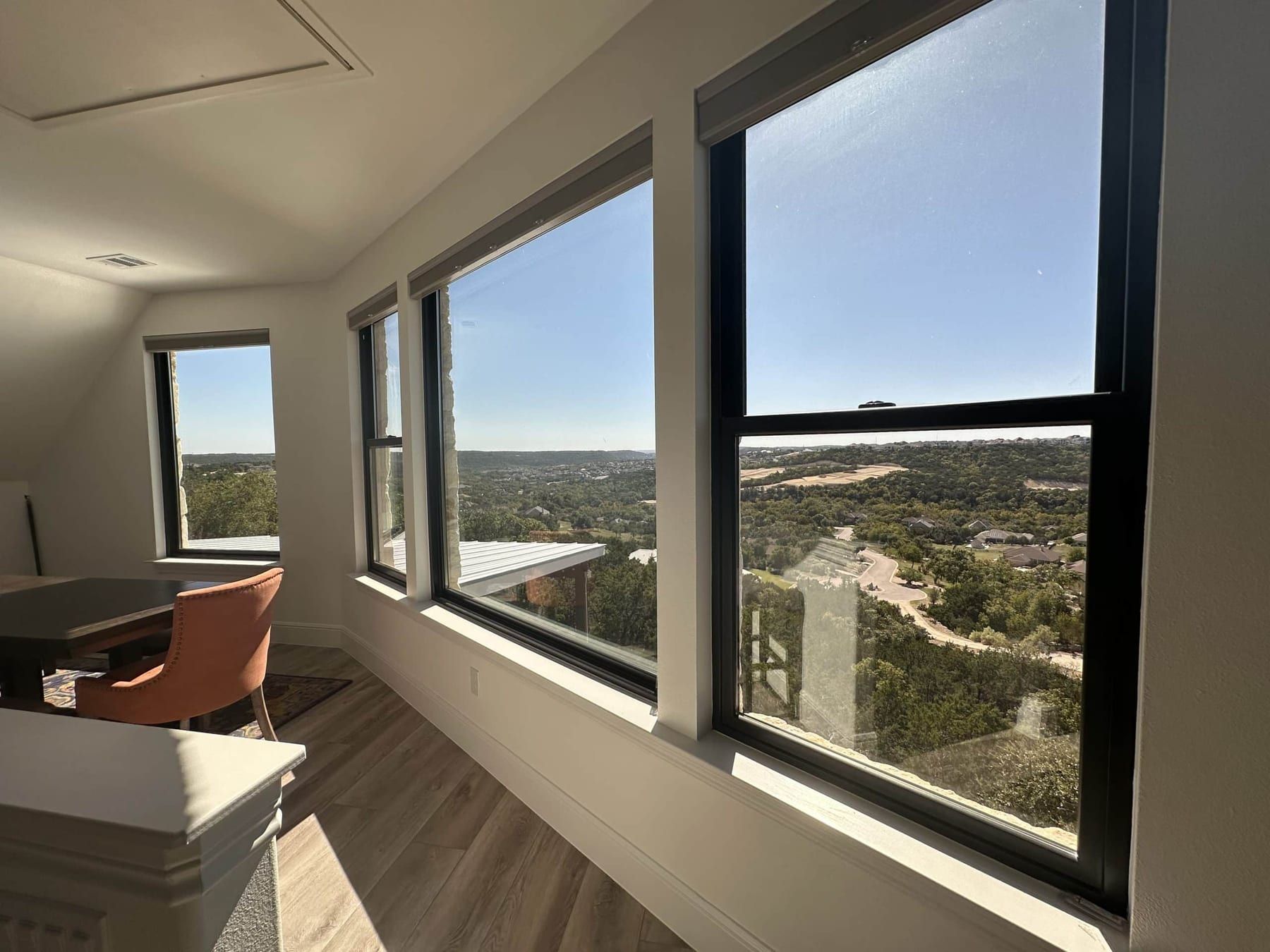 Row of windows in the game room looking out over the Hill Country and the road below