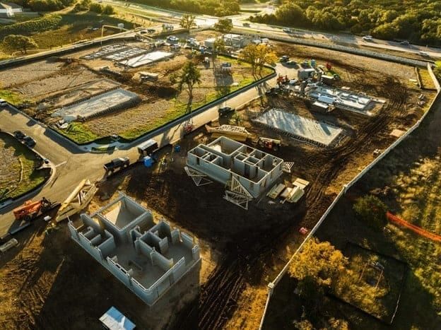 Aerial view of residential construction site with foundations in Austin, TX