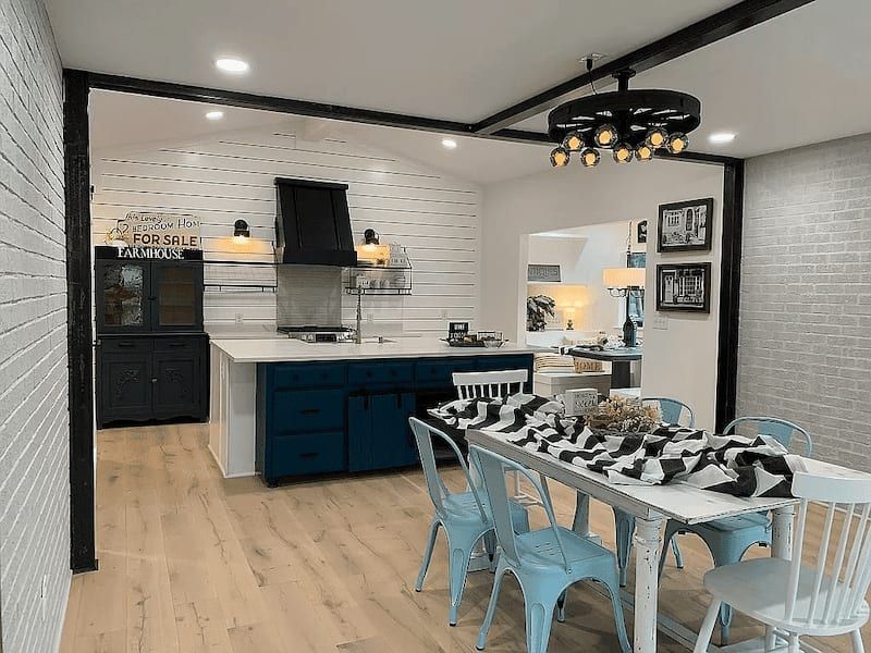 Farmhouse style kitchen and dining area with blue cabinets and white shiplap in Austin, TX home,
