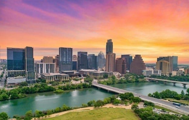 The downtown Austin skyline at sunset, seen across Lady Bird Lake