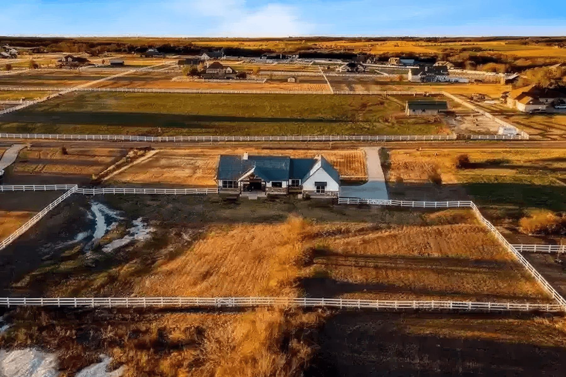Aerial view of a custom home built on fenced acreage near Walburg
