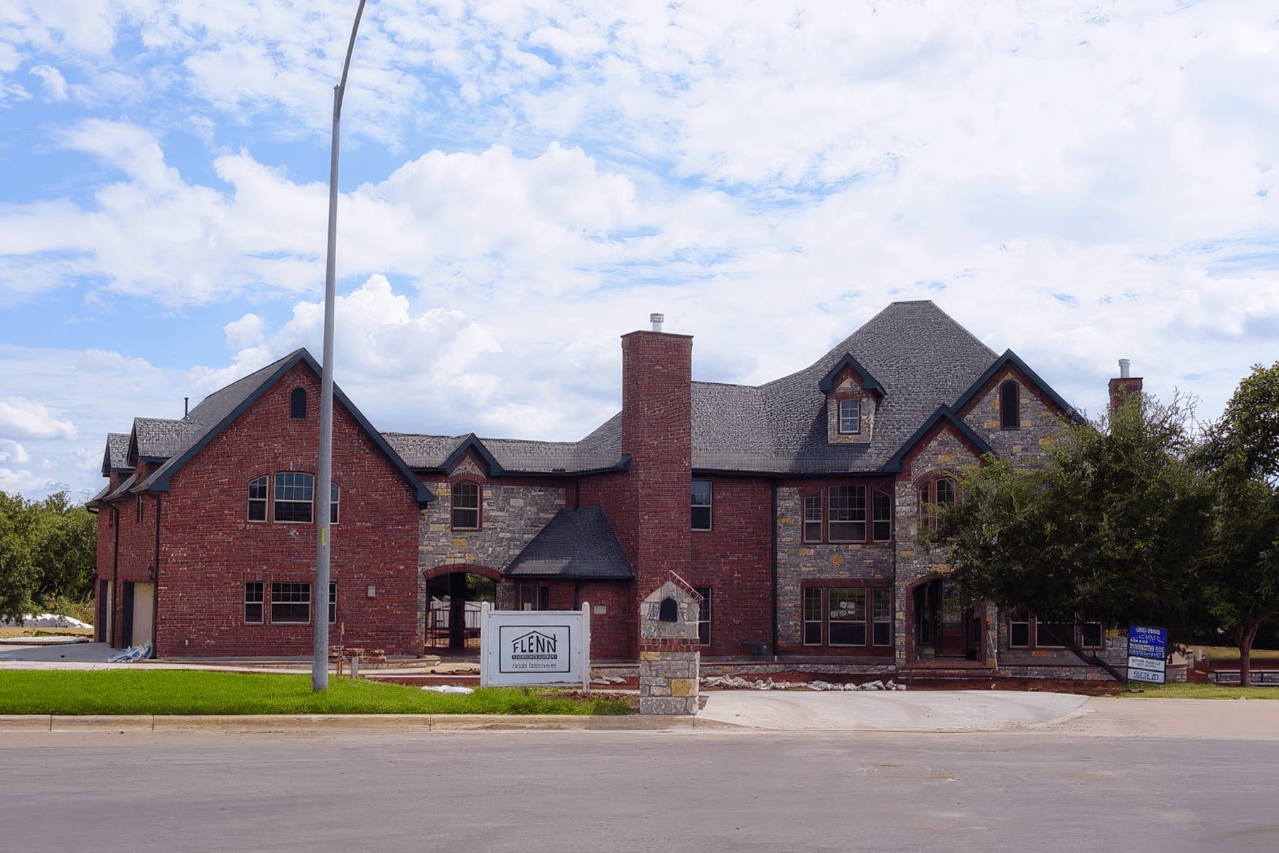 Front elevation of a two-story brick and stone custom home in Austin