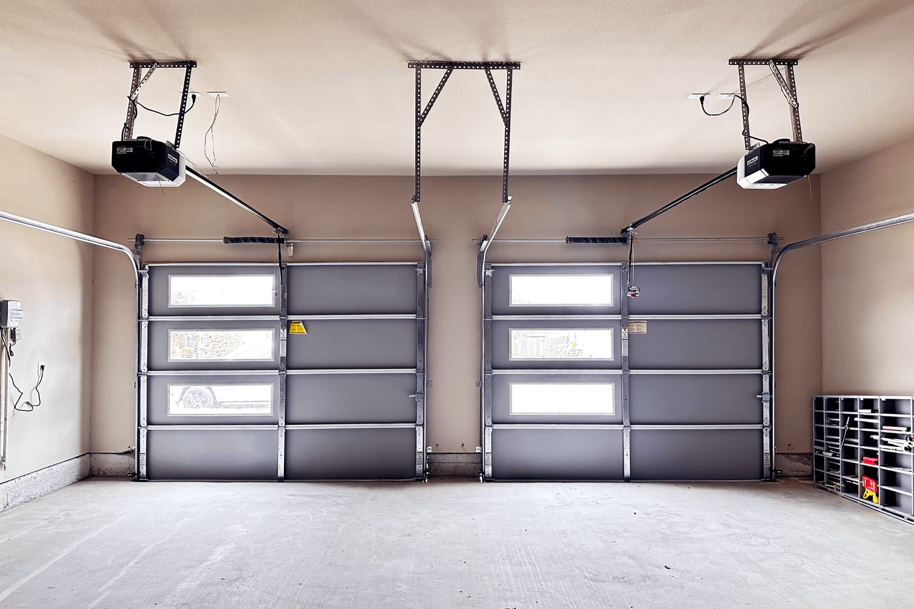 Finished two-bay garage with insulated doors, epoxy floor, and built-in storage