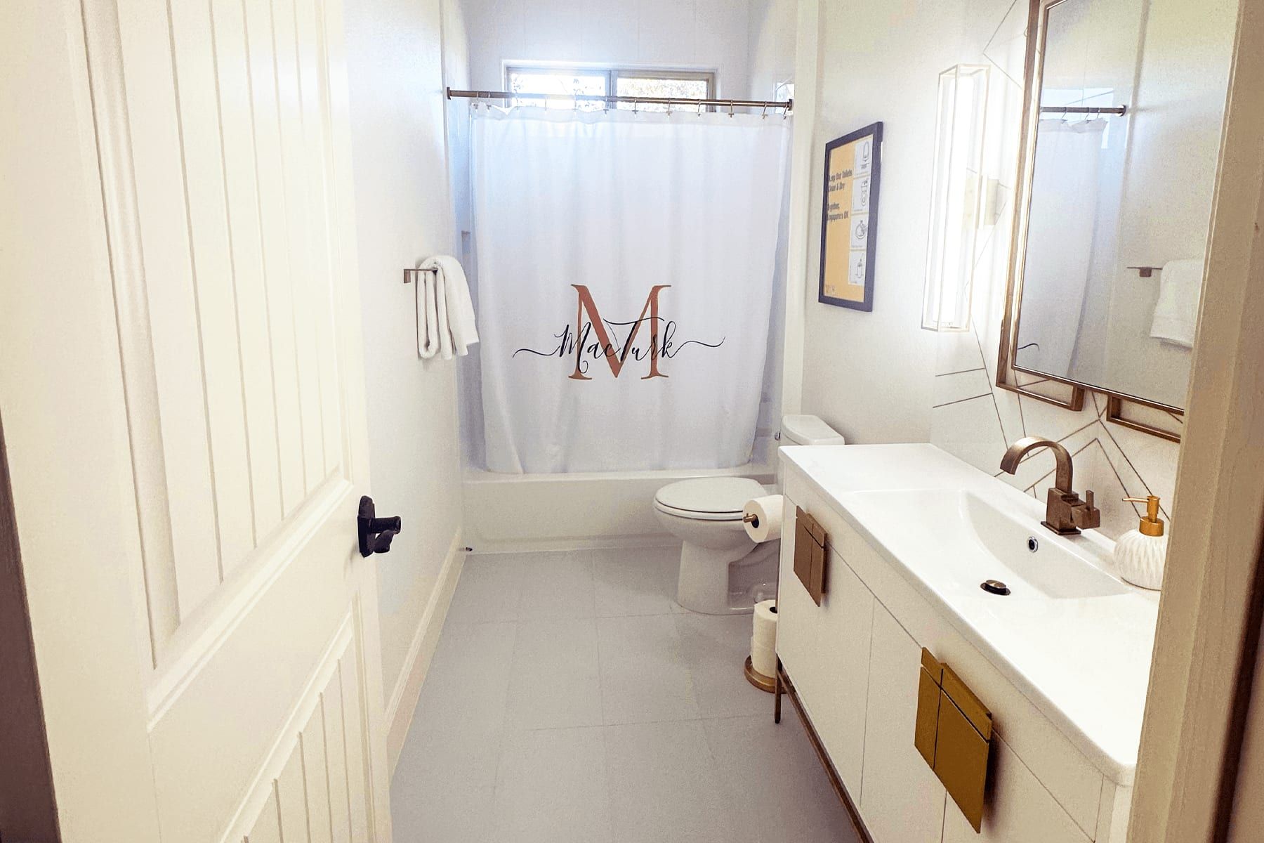 Remodeled guest bath in Leander with a floating vanity and brass fixtures