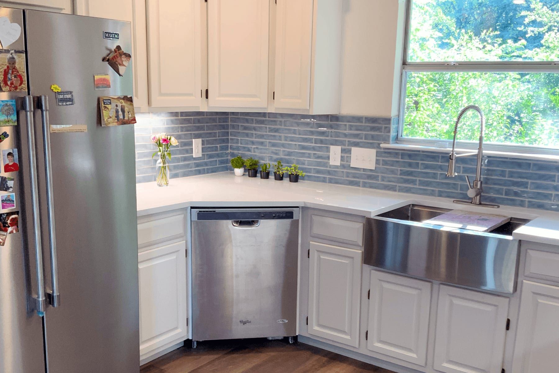 Refreshed kitchen in Hudson Bend with white cabinetry and a laundry nook beyond