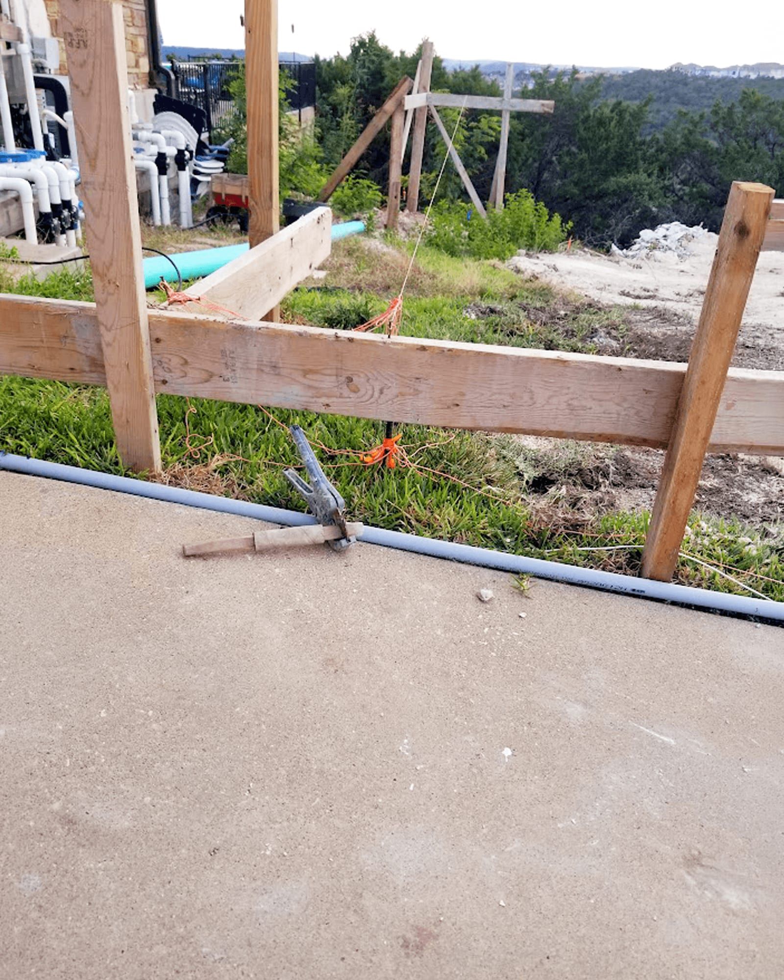 The slab and layout stakes before the covered patio addition