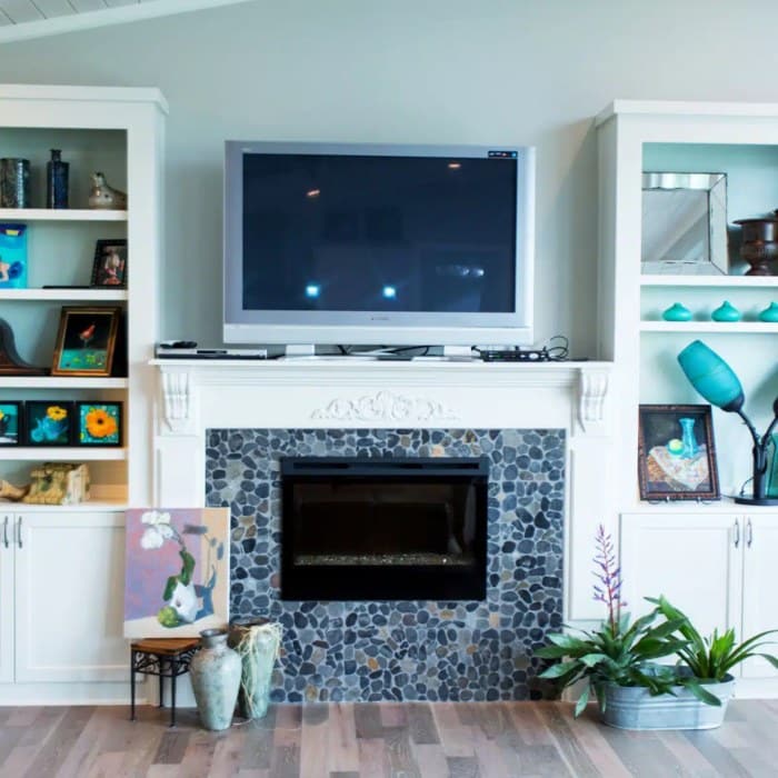 A fireplace with a flat-screen TV mounted above it in Texas<br />
