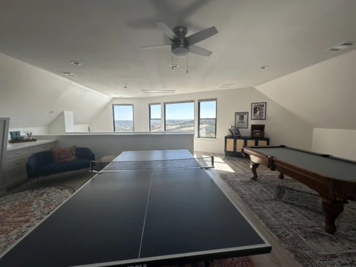 A ping pong table & a pool table are set up in a recreational room in Liberty Hills, TX<br />
