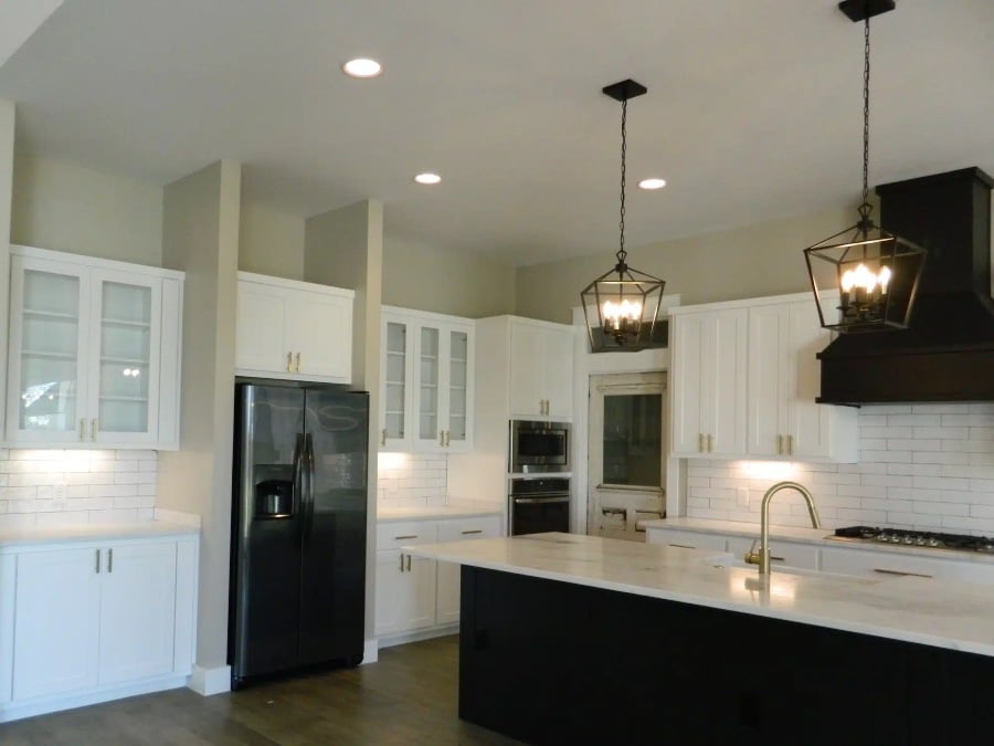 white-cabinets-kitchen A modern kitchen featuring white cabinets & black appliances in Liberty Hills, TX<br />