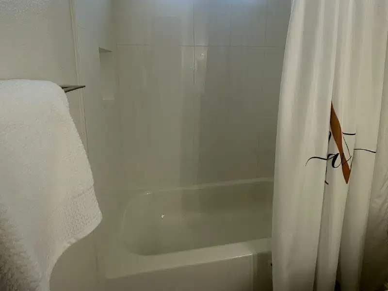 Modern bathtub with white tile surround in Dreamcatcher Bathroom Remodels, Austin TX